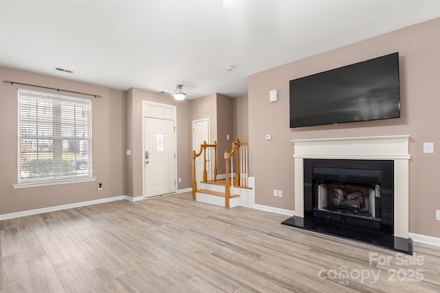 unfurnished living room with light wood-type flooring