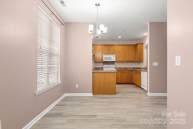 kitchen featuring a chandelier, decorative light fixtures, white appliances, and light hardwood / wood-style floors