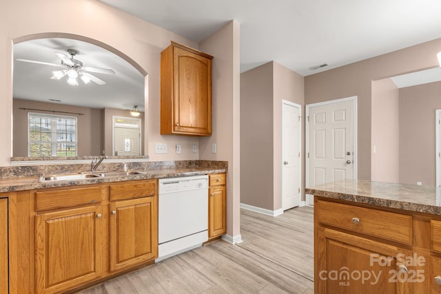 kitchen featuring ceiling fan, sink, white dishwasher, and light wood-type flooring