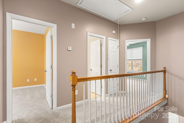 hall with light colored carpet