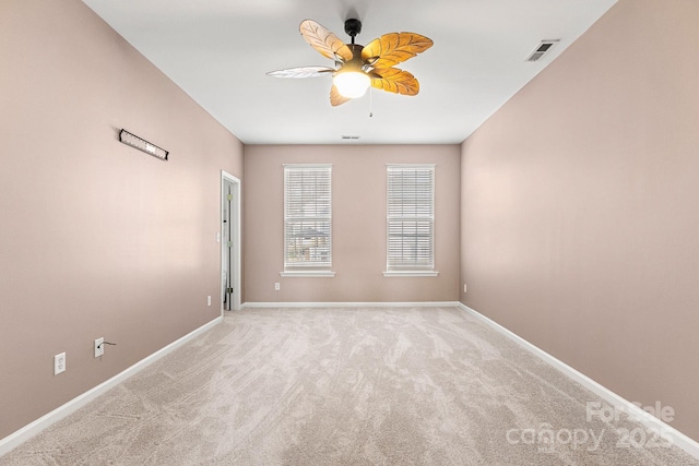 spare room with light colored carpet and ceiling fan