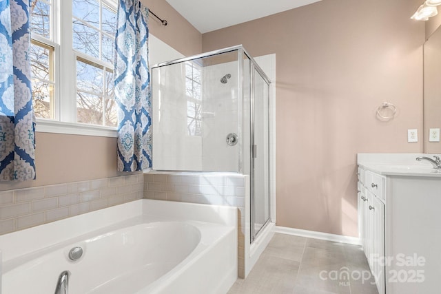 bathroom with plus walk in shower, vanity, and tile patterned flooring