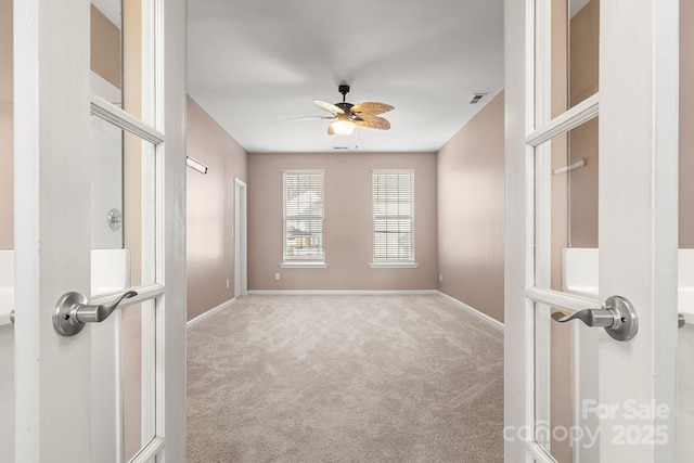 unfurnished room with ceiling fan and light colored carpet