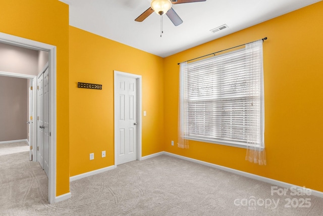 unfurnished bedroom with ceiling fan and light carpet