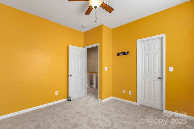 unfurnished bedroom with ceiling fan and light colored carpet