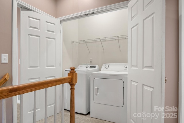 clothes washing area with washing machine and dryer