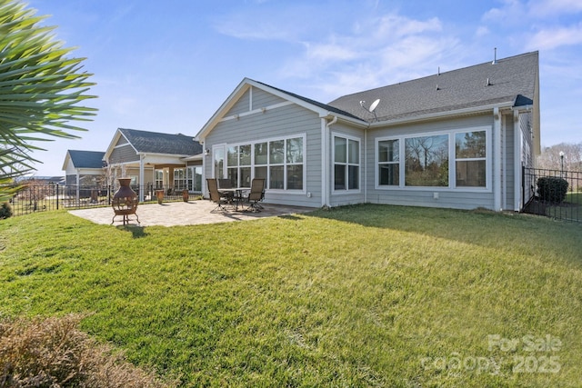 back of house with a yard and a patio