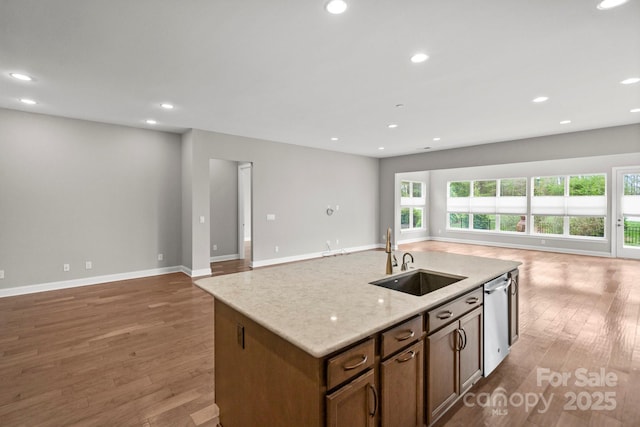 253 Stone Mountain Way, Denver, NC 28037 - kitchen with open floor plan, a sink, stainless steel dishwasher, wood finished floors, and a kitchen island with sink