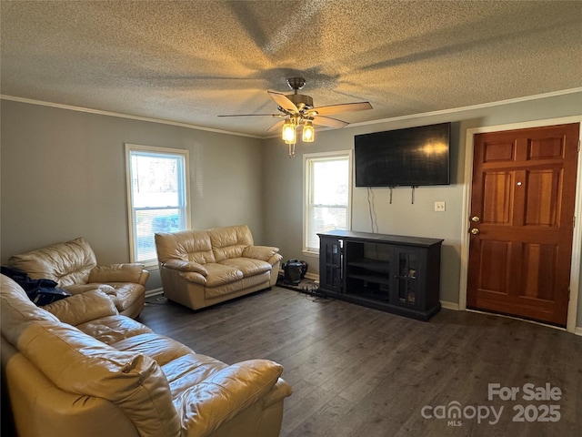 living room with a textured ceiling, dark wood-type flooring, ceiling fan, and ornamental molding