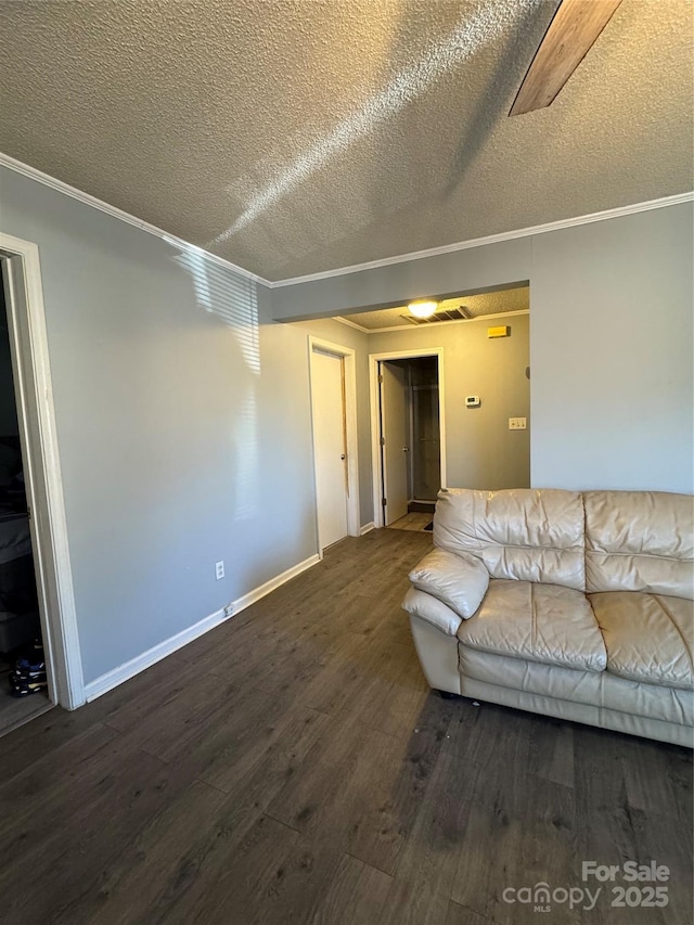 unfurnished living room with dark hardwood / wood-style floors, ornamental molding, and a textured ceiling