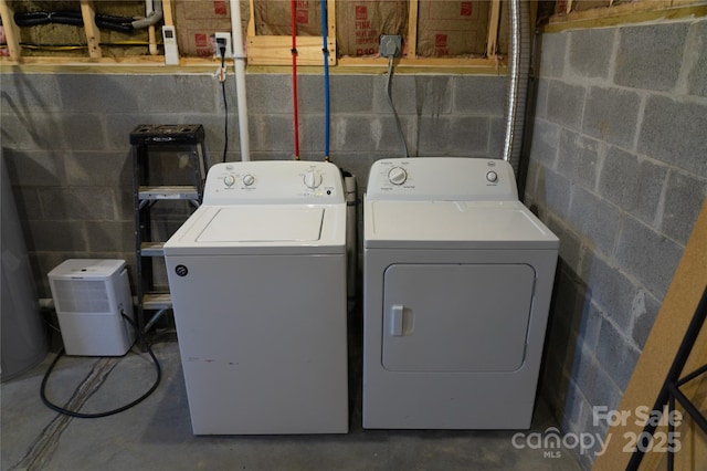 clothes washing area featuring washer and clothes dryer