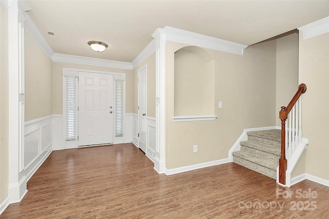 foyer with hardwood / wood-style floors and ornamental molding