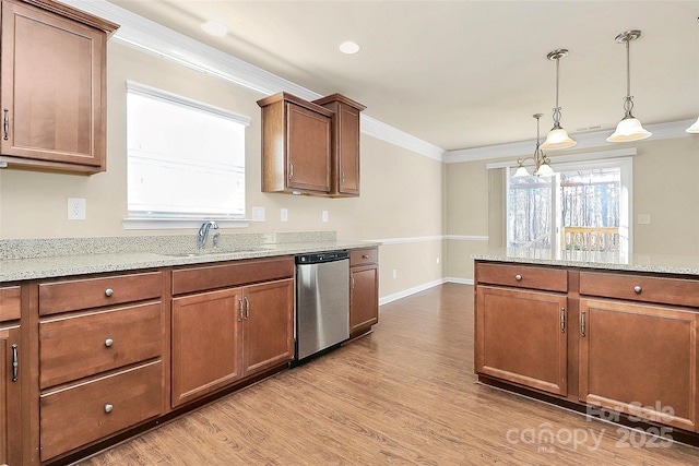 kitchen with light stone countertops, sink, pendant lighting, dishwasher, and light hardwood / wood-style floors