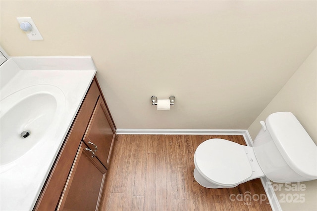 bathroom featuring hardwood / wood-style floors, vanity, and toilet