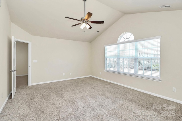 carpeted empty room with ceiling fan and lofted ceiling