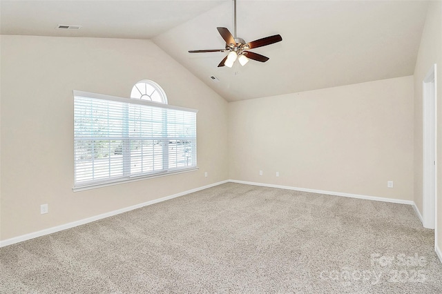 carpeted empty room featuring ceiling fan and vaulted ceiling