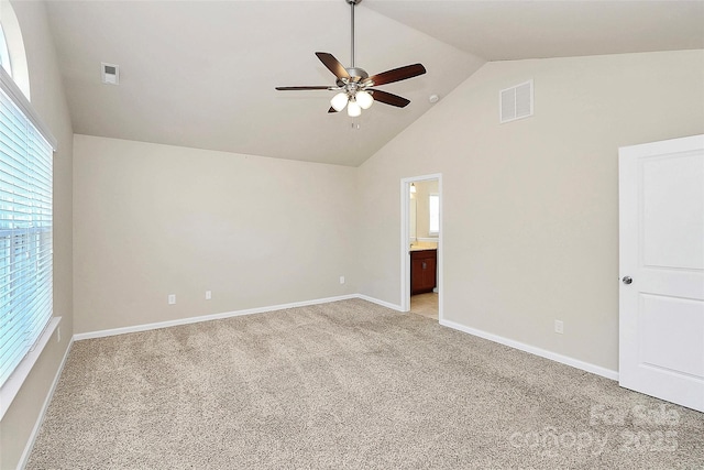 carpeted empty room featuring vaulted ceiling and ceiling fan