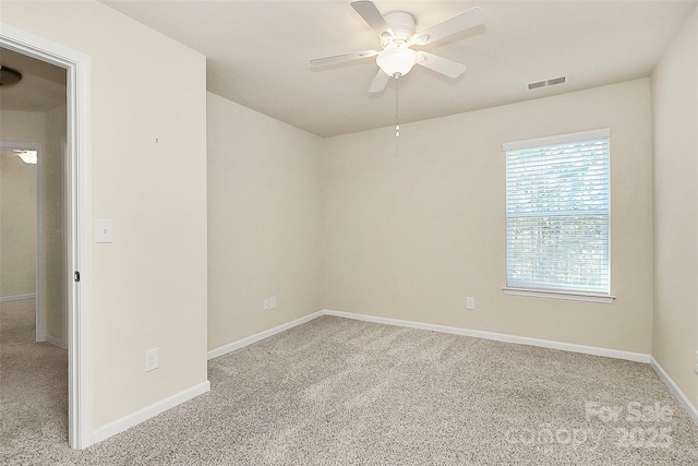 carpeted spare room with ceiling fan