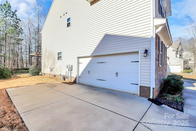 view of side of property featuring a balcony and a garage