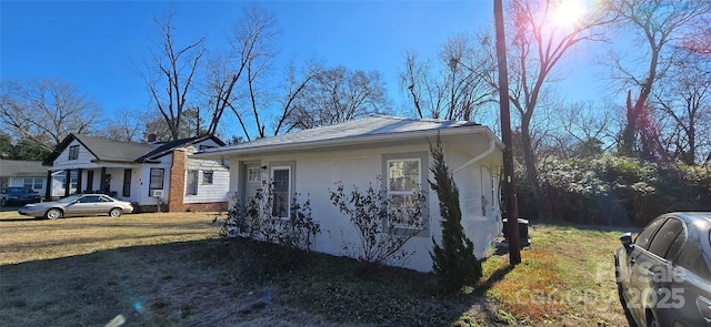 view of property exterior with a yard