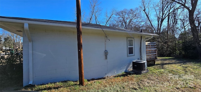 view of side of property with central air condition unit