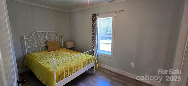 bedroom with multiple windows, dark wood-type flooring, and ornamental molding