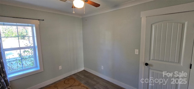 spare room featuring ceiling fan, dark hardwood / wood-style flooring, and crown molding