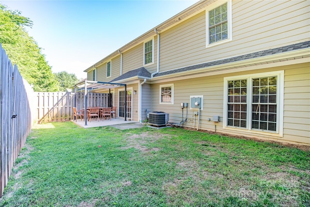 rear view of house with a patio, central AC unit, a pergola, and a lawn