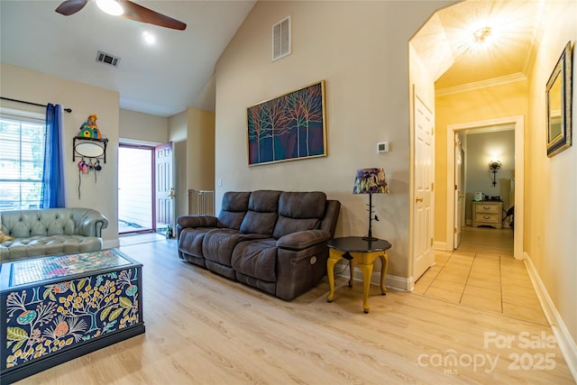 living room with light wood-type flooring, vaulted ceiling, and ceiling fan