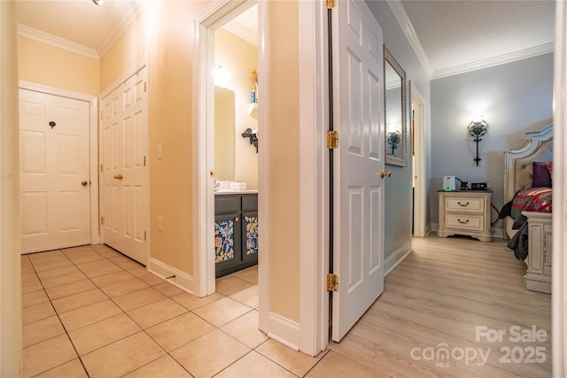 corridor with light tile patterned floors and ornamental molding