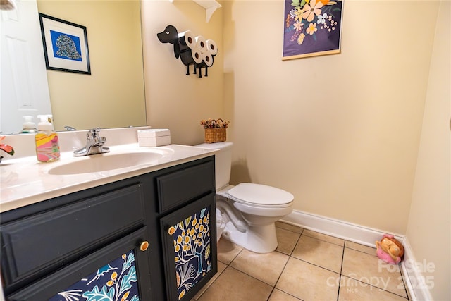 bathroom featuring tile patterned flooring, vanity, and toilet