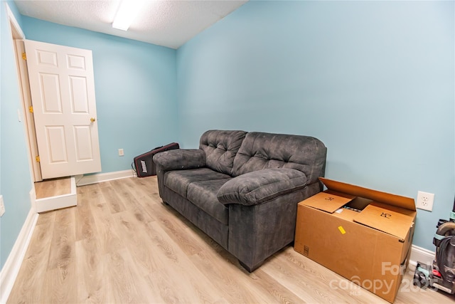 living area featuring a textured ceiling and light wood-type flooring