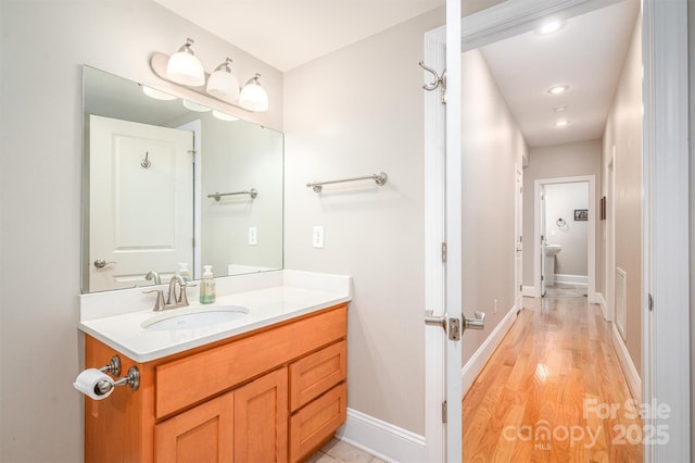 bathroom featuring hardwood / wood-style flooring and vanity