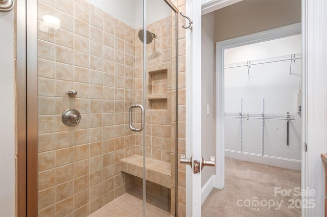 bathroom with a shower with door