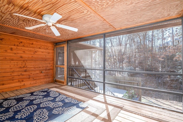 unfurnished sunroom with ceiling fan and wood ceiling