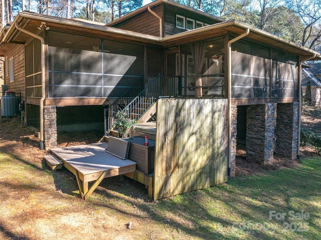 back of property featuring a sunroom and central air condition unit