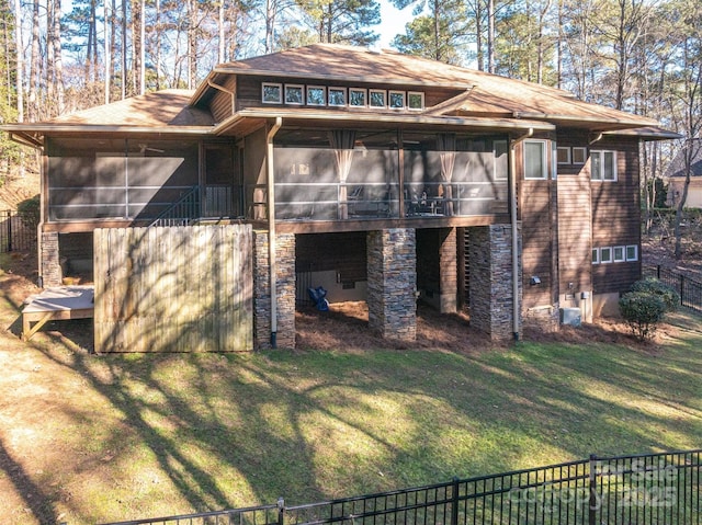 exterior space featuring a lawn and a sunroom