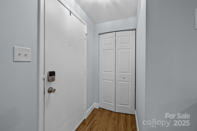 doorway with hardwood / wood-style flooring