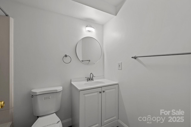 bathroom featuring toilet and vanity