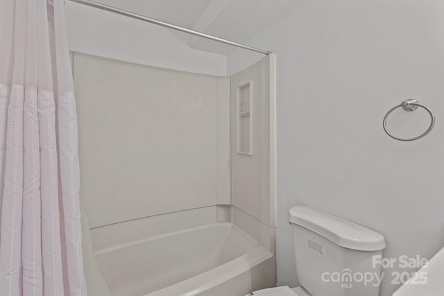 bathroom with shower / bathtub combination with curtain and toilet