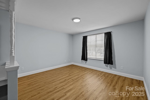 unfurnished room with hardwood / wood-style flooring