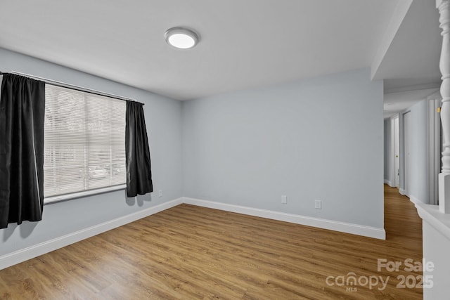 spare room with hardwood / wood-style flooring