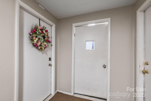 entrance foyer featuring a textured ceiling