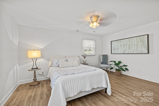 bedroom with hardwood / wood-style flooring and ceiling fan