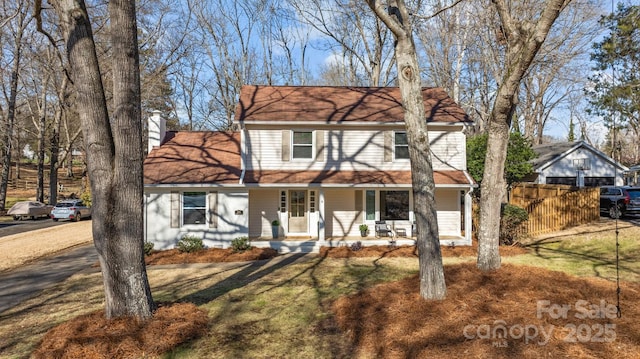 view of front property featuring a porch and a front yard