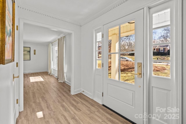 doorway to outside featuring light hardwood / wood-style flooring and ornamental molding