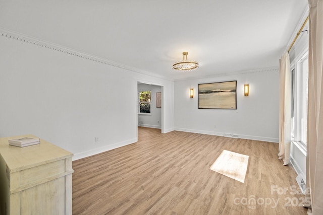 unfurnished living room featuring light wood-type flooring and crown molding