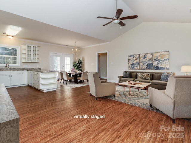 living room featuring ceiling fan, french doors, sink, hardwood / wood-style floors, and lofted ceiling