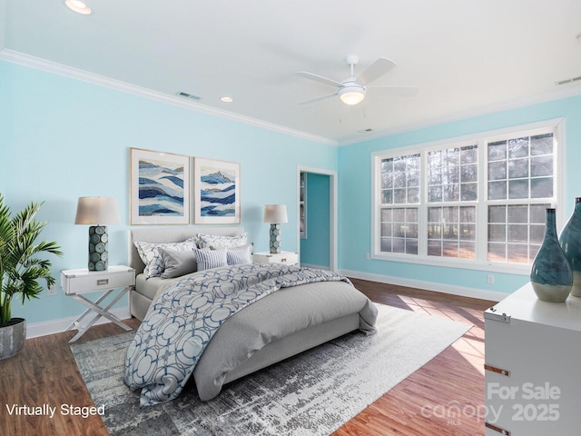 bedroom with ceiling fan, wood-type flooring, and ornamental molding