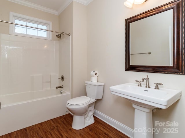 bathroom featuring hardwood / wood-style flooring, shower / bathtub combination, toilet, and crown molding